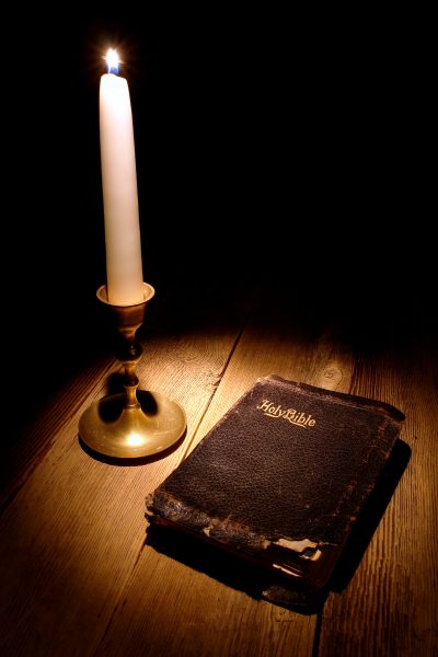 Old Holy Bible Antique Book in Soft Candle Light