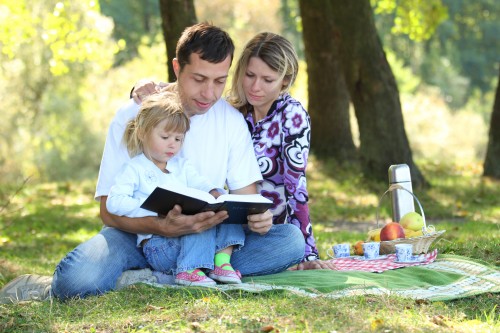 family read the Bible in nature