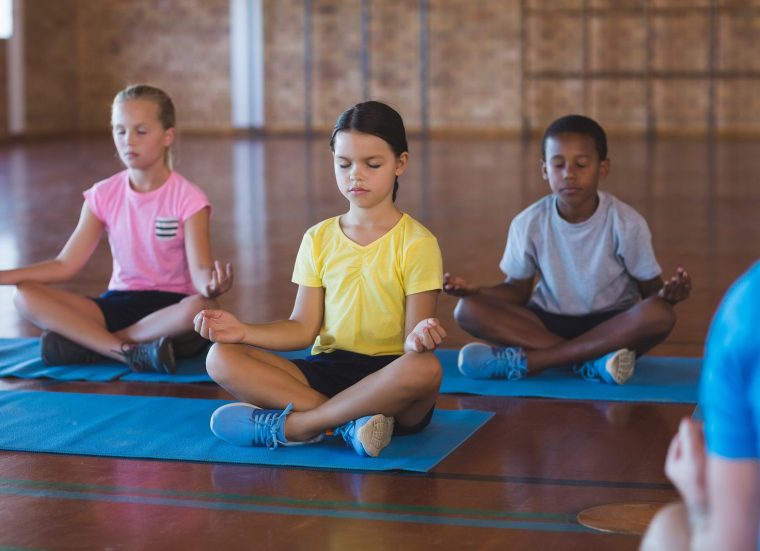 Children at a school doing yoga